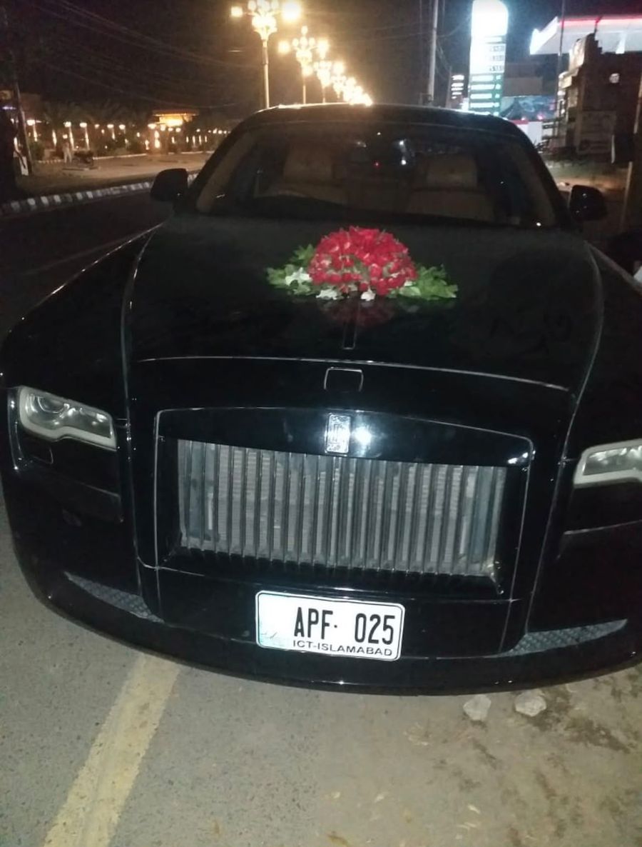 Black Rolls-Royce with flower decoration on the bonnet